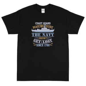 May include: Black t-shirt with a white graphic design that reads "Coast Guard Making Sure The Navy Doesn't Get Lost Since 1790". The graphic also includes a blue and white ship and two anchors.