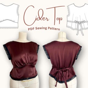 May include: Burgundy Cider Top PDF sewing pattern. The image shows a burgundy satin top with black lace trim and a tie back. The pattern includes front and back views of the top, along with a line drawing of the top.