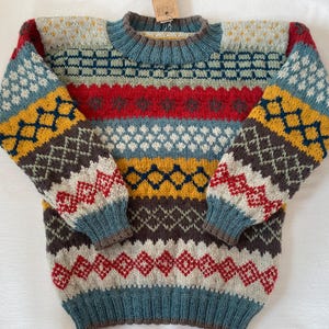 Children&#39;s sweater size 134/140 in colorful hand-knitted from pure new wool with alpaca