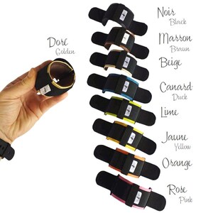 May include: Ten wristbands in different colors, including black, brown, beige, lime, yellow, orange, pink, and gold. Each wristband has a black strap with a white logo.