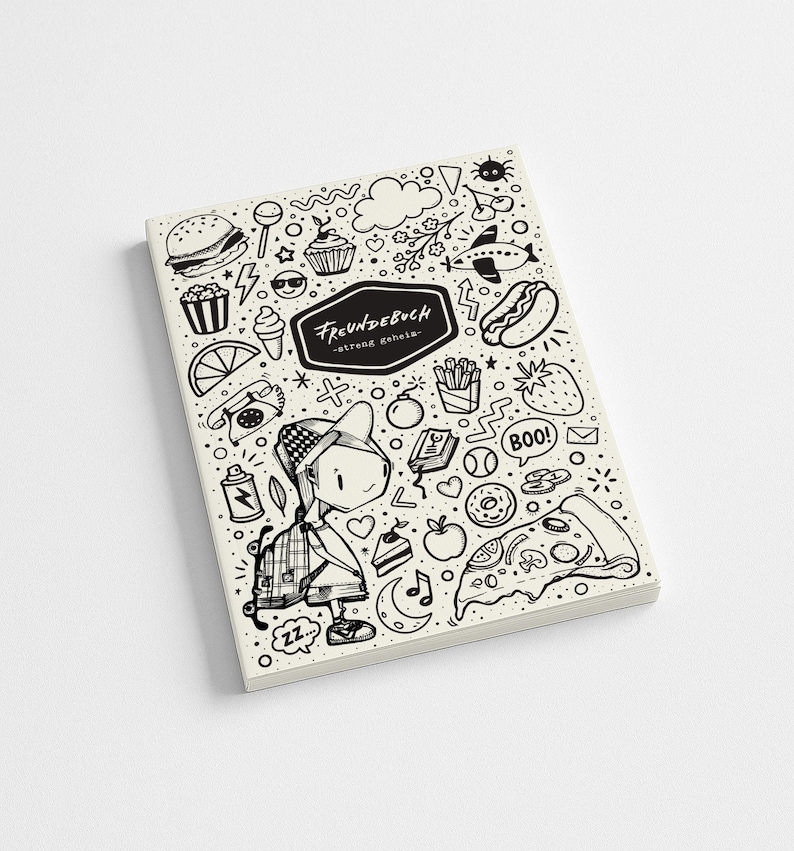 May include: A cream-colored notebook with a black and white doodle design. The cover features a cartoon illustration of a person with a backpack, surrounded by food and other objects. The text "FREUNDEBUCH" is displayed in a black banner.