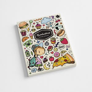 May include: A notebook with a cream-colored cover, featuring a whimsical illustration of a girl with a backpack, surrounded by doodles of food, a plane, and the text "FREUNDEBCH". The notebook is filled with colorful drawings.
