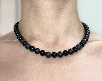 Matte black and shiny black natural onyx beaded necklace with sterling silver closure.