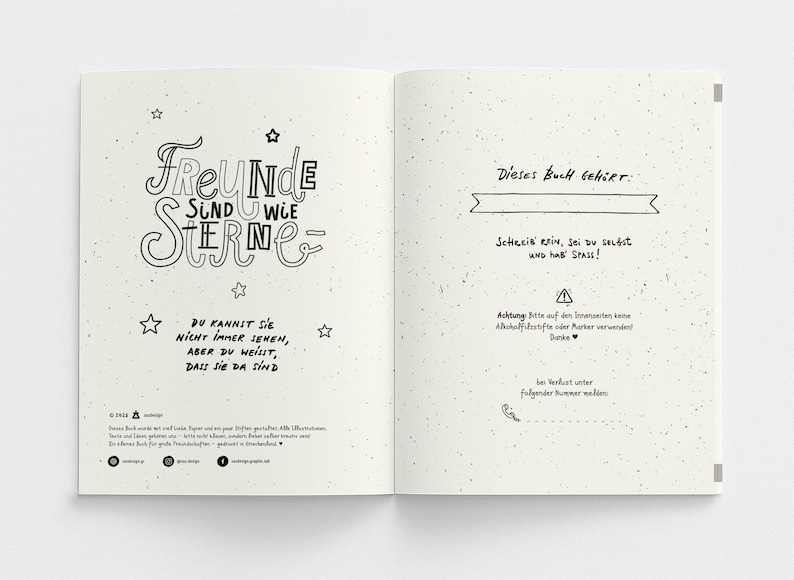 May include: Open notebook with a cream-colored speckled paper. The left page has the words "FREUNDE SIND WIE STERNE" in a decorative font, with star illustrations. The right page has text in German.