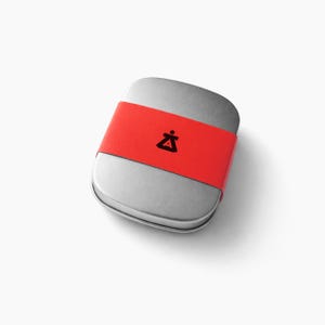 Minimalist metal jewelry gift tin with modern branded sleeve packaging, contemporary storage box for geometric Bauhaus style statement necklace, sleek artisan jewelry presentation, stylish handmade necklace packaging on soft neutral background