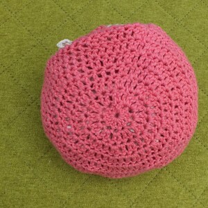 May include: A pink crocheted hat with a white crocheted lining.