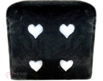 May include: Black plush dice with four white hearts on the sides. The dice is a soft, fuzzy toy.