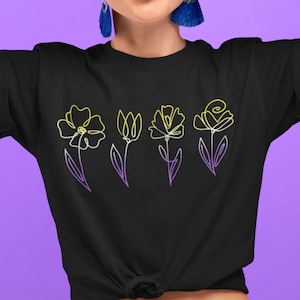 May include: Black t-shirt with a line drawing of five flowers in yellow and purple. The flowers are stylized and have a simple design.