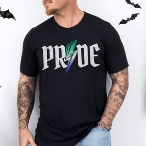 May include: Black t-shirt with the word "PRIDE" in a distressed white font, featuring a lightning bolt design in shades of green, blue, and purple. The shirt is a casual wear item.