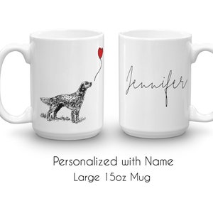May include: White ceramic mug with a black and white illustration of a dog holding a red balloon. The mug has the name "Jennifer" written on it in black cursive. The mug is 15 ounces.