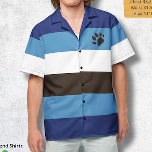 May include: Short-sleeved button-down shirt with a color block design in shades of blue, white, and brown. A paw print is on the chest. The shirt has a camp collar. The text "On Trend Shirts" and "Make a Statement" are at the bottom.