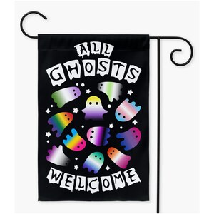 May include: A black garden flag with the text "All Ghosts Welcome" in white dripping letters. The flag features a circle of colorful ghosts with different pride flag colors.