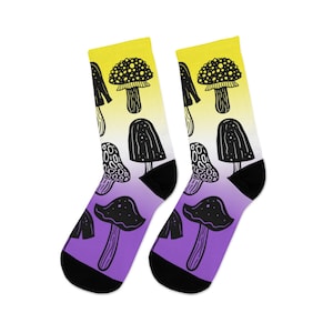 May include: A pair of socks with a gradient design of yellow, purple, and black. The socks feature a repeating pattern of black mushrooms with white spots.