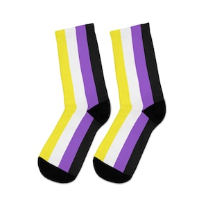 May include: A pair of black, white, yellow, and purple striped socks. The socks are made of a soft, comfortable material and are perfect for everyday wear.