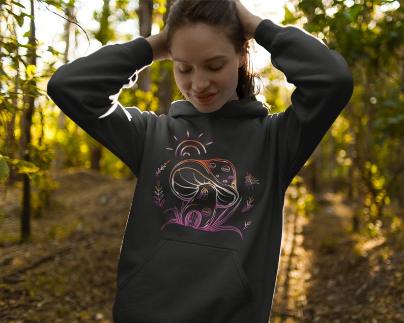 May include: Black hoodie with a graphic of a mushroom with a sun and leaves in pink, orange, and yellow.