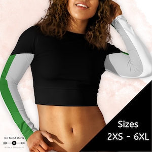 May include: Black long-sleeved crop top with green and white color block sleeves. The top has a round neckline and is available in sizes 2XS - 6XL.
