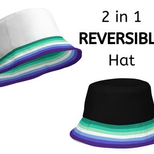 May include: A reversible bucket hat with a white side and a black side. Both sides feature a multi-colored stripe pattern in shades of blue, green, and white. The hat is labeled "2 in 1 REVERSIBLE Hat".