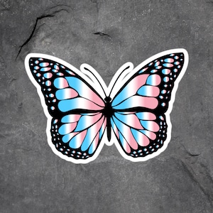 May include: A blue, pink, and white butterfly with black outlines. The butterfly is a symbol of transgender pride.