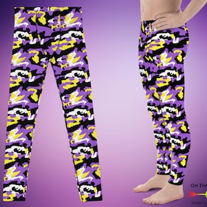 May include: Purple, yellow, black, and white camouflage print leggings. The leggings are shown on a model.