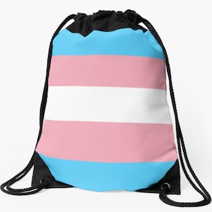 May include: A drawstring bag with the transgender pride flag printed on it. The flag has light blue, pink, and white horizontal stripes.