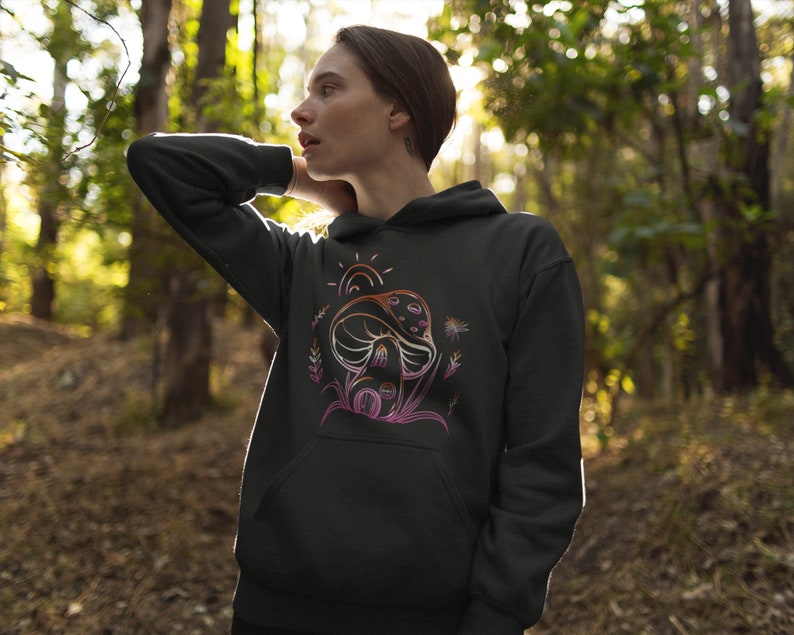 May include: Black hooded sweatshirt with a colorful graphic of a mushroom with a sun and flowers.