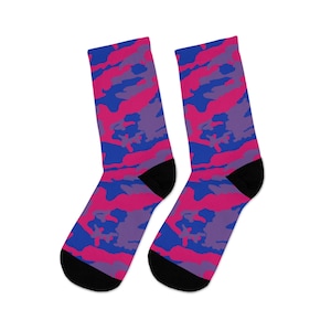 May include: A pair of black socks with a pink, blue, and purple camouflage pattern.