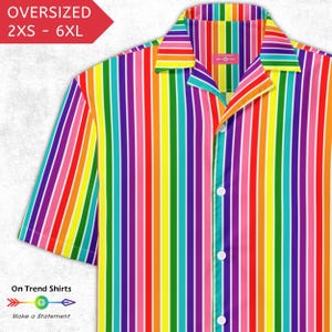 May include: A short-sleeved, button-down shirt with vertical rainbow stripes. The shirt has a camp collar and white buttons. Text on the image reads "OVERSIZED 2XS - 6XL" and "On Trend Shirts. Make a Statement."