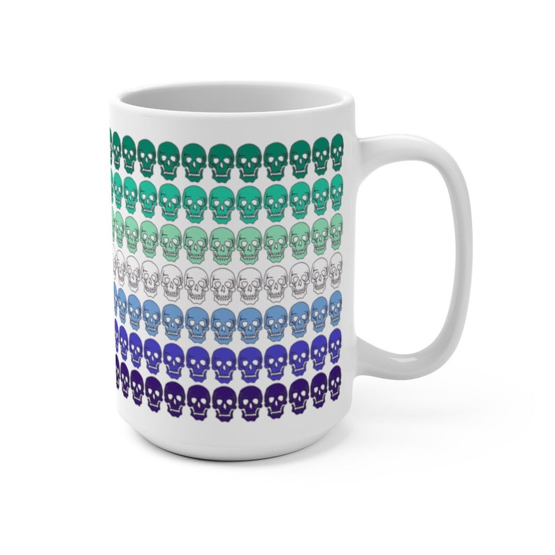 May include: White ceramic mug with a pattern of skulls in shades of green, blue, and purple. The skulls are arranged in rows, with the colors gradually transitioning from green to purple.