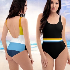 May include: A black one-piece swimsuit with a colorful stripe design across the bottom. The swimsuit has a scoop neck and a racerback style.