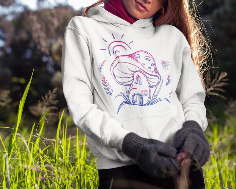 May include: White hoodie with a pink and blue line drawing of a mushroom house with a sun and flowers.