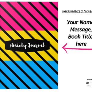 May include: A spiral bound notebook with a pink, yellow and blue striped cover. The cover has black diagonal stripes and the words "Anxiety Journal" in a black oval. The notebook is personalised with the text "Personalized Notebook" and "Your Name, Message, Book Title here".