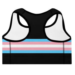 May include: Black sports bra with a transgender pride flag design. The flag has light blue, pink, and white stripes.