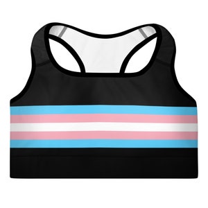 May include: Black sports bra with a horizontal stripe pattern in light blue, white, and pink. The stripes are reminiscent of the transgender pride flag.
