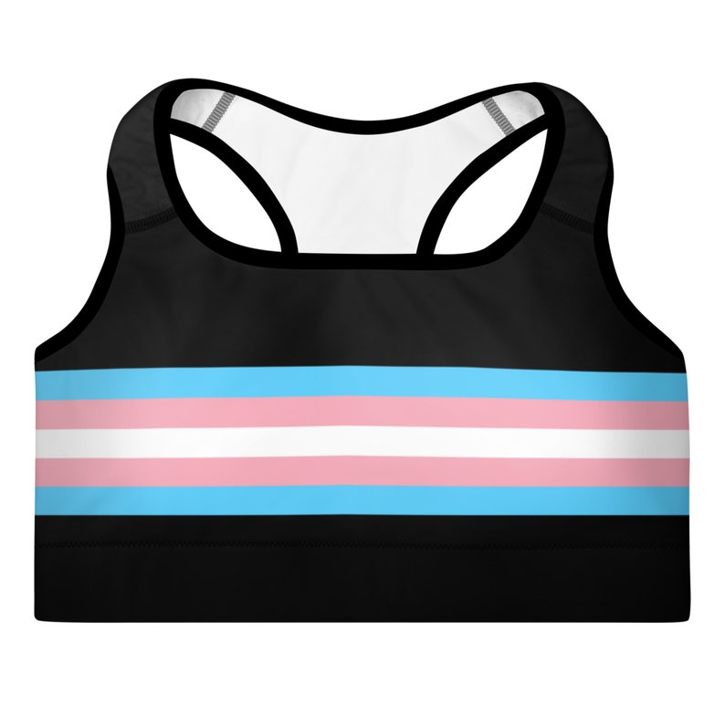 May include: Black sports bra with a horizontal stripe pattern in light blue, white, and pink. The stripes are reminiscent of the transgender pride flag.