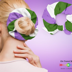 May include: A colorful scrunchie with a green, white, and purple striped pattern. The scrunchie is shown on a person's hair and also displayed separately. The image includes the text "On Trend Shirts" and "Make a Statement".