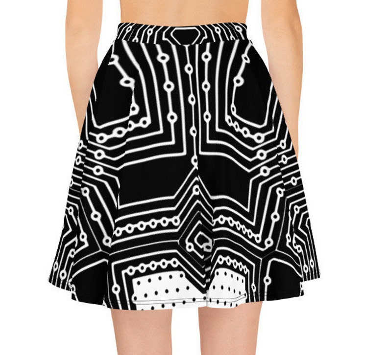 May include: A black and white skater skirt with a circuit board pattern. The skirt has a white polka dot trim at the bottom.