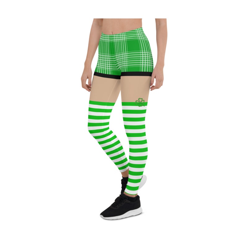 May include: Green and white striped leggings with a green plaid pattern on the top portion. The leggings have a shamrock design on the thigh.