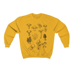 May include: A yellow sweatshirt with a black and white illustration of various types of mushrooms.