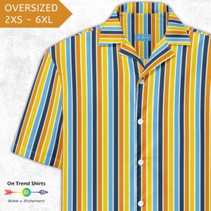 May include: An oversized button-down shirt with vertical stripes in yellow, blue, navy, and orange. The shirt has short sleeves and a camp collar. The text "OVERSIZED 2XS - 6XL" is in the upper left corner. The text "On Trend Shirts" and "Make a Statement" are at the bottom.