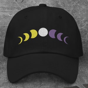 May include: Black baseball cap with an embroidered design of a crescent moon in yellow, white, and purple.