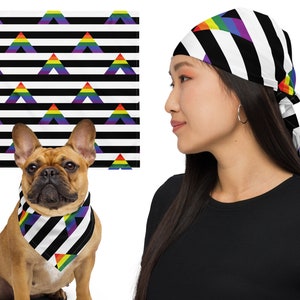 May include: A black and white bandana with a rainbow triangle pattern. The bandana is tied around a person's head and a dog is wearing a matching bandana around its neck.