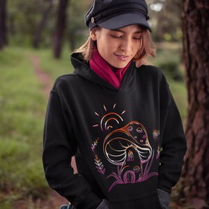May include: Black hoodie with a graphic of a mushroom house with a sun and flowers in a rainbow color scheme.