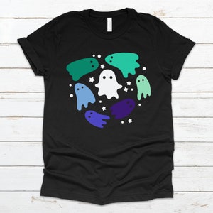 May include: Black t-shirt featuring a design of white and multi-coloured ghosts in a circle. The ghosts are in shades of green, blue, and purple.