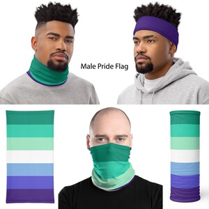 May include: A face mask with a green, light green, white, light blue, and purple striped pattern. The mask is shown on a person's face and on a flat surface. The text "Male Pride Flag" is visible in the image.
