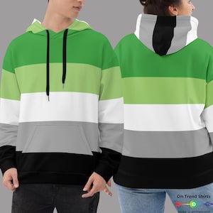 May include: A green, white, gray, and black striped hoodie. The hoodie has a drawstring hood and a kangaroo pocket.
