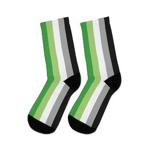 May include: A pair of black socks with green, white, and gray stripes. The socks are a representation of the asexual pride flag.