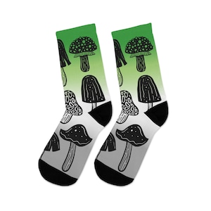 May include: A pair of black and white socks with a green ombre design featuring a repeating pattern of mushrooms.