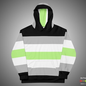 May include: A black, grey, and light green striped hoodie with a drawstring hood. The hoodie has a large pocket on the front.