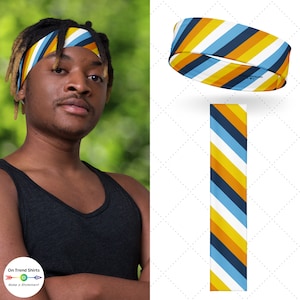 May include: A blue, white, yellow, and orange striped headband. The headband is shown on a person's head and laid flat.