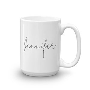 May include: White ceramic coffee mug with a black cursive inscription that reads "Jennifer".